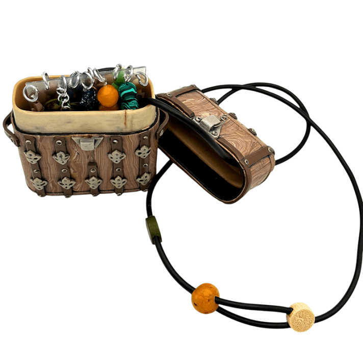 Xan's chest-shaped inro inspired me to create a mini version of a sculpture I was working on at that time: a wooden trunk filled with strings of various gemstones, ivory, coral, wood, etc., all made of polymer clay. It also inspired me to create my first inro (following Donna Kato's tutorial). The result: a trunk-shaped inro, wearable and fully functional, filled with a hidden treasure of beads.